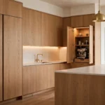 Luxury kitchen with concealed storage — handleless oak cabinetry and hidden coffee station